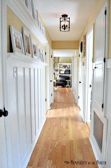 https://www.simplicityinthesouth.com/wp-content/uploads/2013/03/Board-and-batten-hallway-with-gallery-shelves.jpg